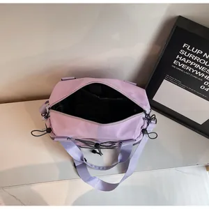 Top view of a light purple nylon travel tote showing the spacious interior and reinforced straps