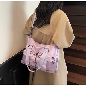 Macro shot of light purple travel tote bag with side mesh pocket and cord detailing