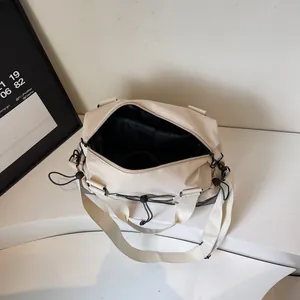 Large cream lightweight travel tote bag with double handles and multi-pocket interior