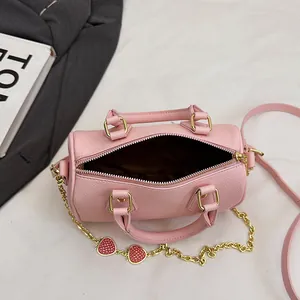 Pink lychee leather cylinder Boston bag with strawberry chain and dual handles