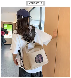 Detailed back view of khaki nylon backpack featuring elephant rhinestone patch and straps