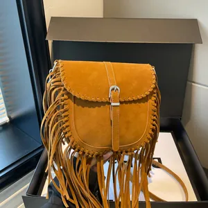 Handmade brown faux suede saddle bag with fringe details and crossbody strap