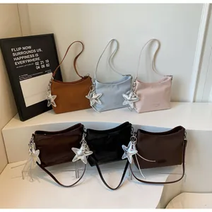 Group of six minimalist crescent shoulder bags in various colors with star charms