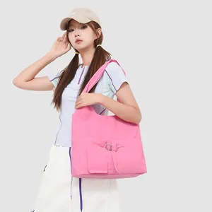 Grote roze schoudertas voor dames met decoratieve gespzak en trendy linten