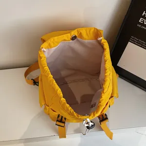 Bright yellow nylon backpack with drawstring closure and buckle straps for summer sports
