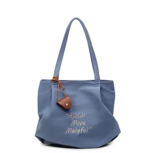 Morandi blue large capacity tote bag with minimalist embroidery and leather pendant