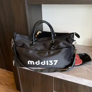 Large black travel duffel bag with a dedicated side shoe compartment and shoulder strap