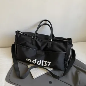 Minimalist large capacity black travel bag with mddl37 logo and adjustable shoulder strap