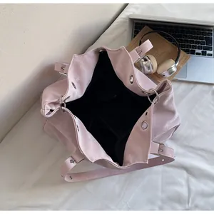 Pink suede tote bag showing large capacity interior, black lining and internal pockets