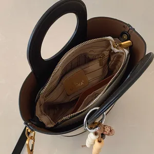 Vintage canvas emmertas in beige en zwart met binnenvak en kralen accessoire