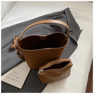 Brown retro frosted leather bucket bag set with wide shoulder strap and inner pouch