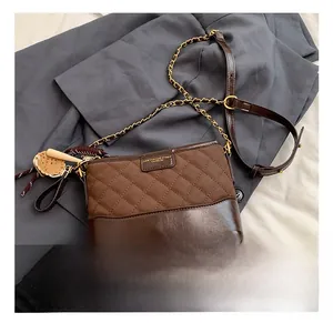 Detail of vintage matte bucket bag with quilted stitching, chain strap and charm