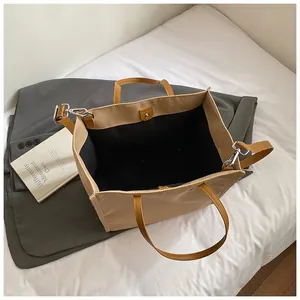 Minimalist beige tote bag with brown leather straps and interior space layout