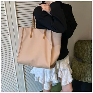 Large capacity apricot tote bag shown in use with brown shoulder straps for women