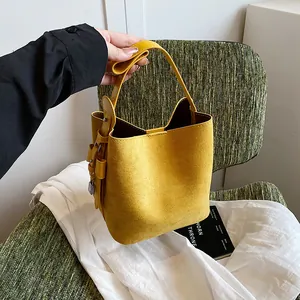 Fashionable yellow frosted bucket bag with metal lock detail for daily commute wear