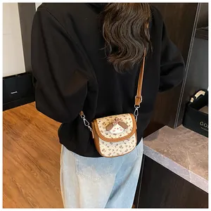 Close-up of floral crossbody bag with cute animal plush detail on model's back