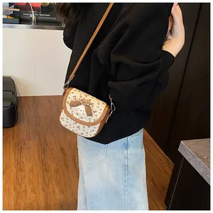 Floral canvas crossbody bag with cartoon dog motif shown on model in cozy room