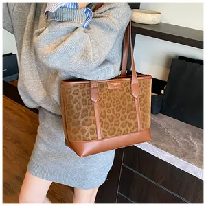 Detail of vintage leopard print tote bag with brown faux leather trim and thin straps