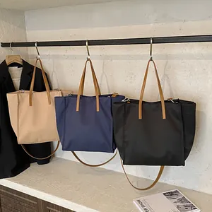 Minimalist nylon tote bag in beige navy and black with leather straps for daily commute