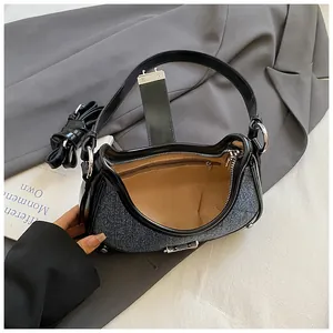 Blue denim and black leather underarm shoulder bag with silver hardware and inner zip pocket