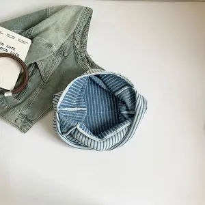 Minimalist blue and white striped canvas tote bag in a casual top-down flat lay view