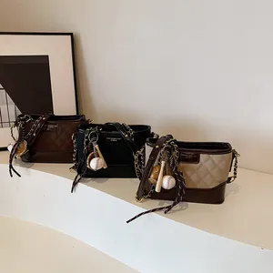 Three-piece set of quilted leather bucket bags with baseball charms and chain straps
