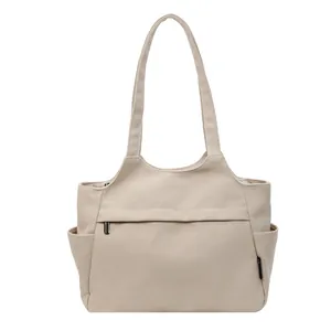 Grand sac cabas beige en nylon avec bandoulière et poche zippée pour le voyage