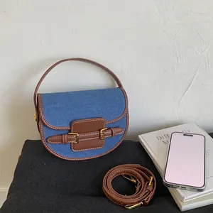 Borsa a sella retrò in denim e pelle marrone con tracolla regolabile da donna