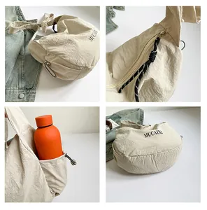 Detailed views of beige nylon crescent bag showing large capacity and zipper details