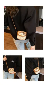 Detail of vintage floral canvas crossbody bag with 3D plush puppy and leather strap