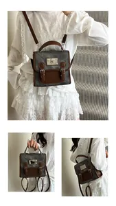 Detailansicht des grauen Retro-Rucksacks mit braunen Lederriemen und Metallbeschlägen