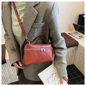 Brown crocodile pattern crossbody bag shown with a gray herringbone blazer outfit