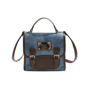 Vintage College Rucksack aus blauem Denim mit braunem Lederbesatz und Metallschnallen