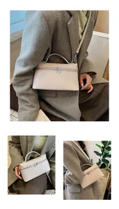Detail view of beige crocodile embossed textured leather bag with dual-way metal zippers