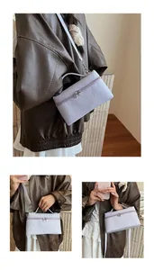Detail of light purple crocodile pattern mini bag with zipper and adjustable strap
