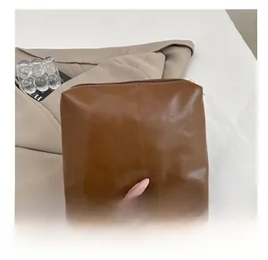 Detail of the brown PU leather inner pouch with a smooth zipper for women's bucket bag