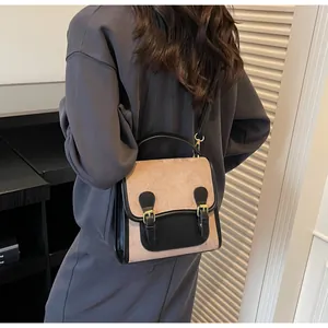 Detailed back view of a retro color-block handbag with adjustable strap on a model