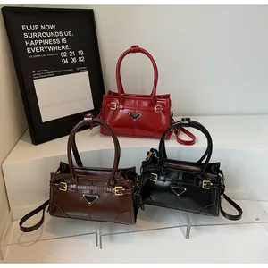 Detail view of glossy leather handbags with triangle metal buckle in three colors