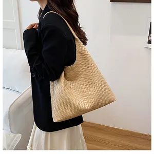 Detailed view of beige woven tote bag showing premium herringbone texture and PU leather