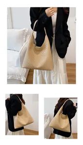Close-up of beige woven bucket bag featuring herringbone pattern and slim leather straps