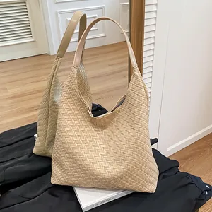 Chic woven tote bag in beige with premium leather handles, minimalist bucket style for daily use