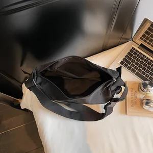 Minimalist black large capacity crossbody bag with adjustable wide strap and inner pocket