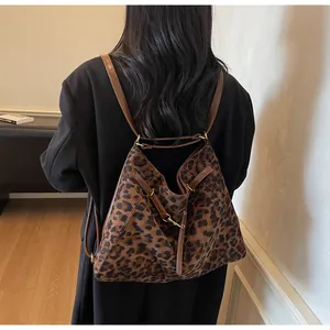 Detail of leopard print tote bag showing versatile straps and texture on a model