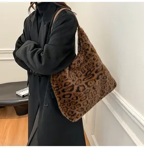 Detail of large leopard print plush tote bag showing soft faux fur texture and shoulder strap