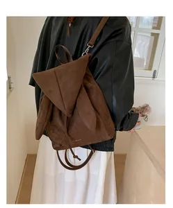 Détail du sac à dos en daim marron foncé avec oreilles de lapin et logo Pinkink gravé