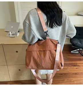Detailed view of the large brown nylon tote bag with adjustable shoulder strap