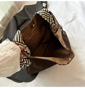 Détail de l'intérieur du grand sac cabas avec doublure rayée et boucle magnétique
