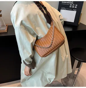 Détail du sac hobo marron tissé avec une chaîne en métal argenté élégante pour femmes