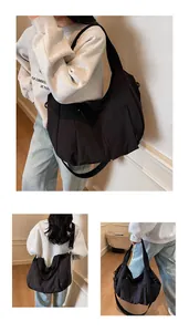 Detail view of a large black nylon hobo bag featuring side pockets and soft pleats