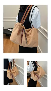 Detail of plush tote bag with leather straps and cute bear charm in autumn style